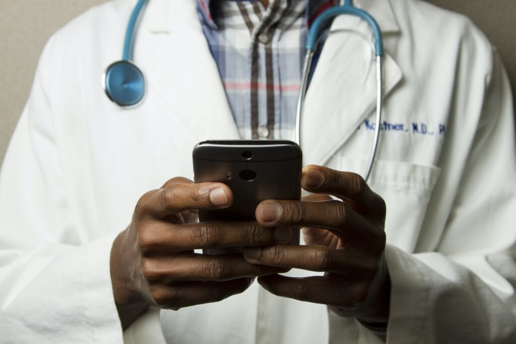 Doctor checking a mobile phone
